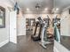 The home gym has exercise equipment, a mirrored wall, and plenty of space for working out at 8957 Old Southwick Pass, Johns Creek, GA 30022