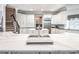 Spacious kitchen with white cabinetry, stainless steel appliances, an island, and granite countertops at 8957 Old Southwick Pass, Johns Creek, GA 30022