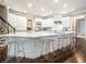 Spacious kitchen with large island, modern seating, and white cabinets offering both style and functionality at 8957 Old Southwick Pass, Johns Creek, GA 30022