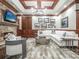 The living room has a stone fireplace, coffered ceilings, built-in cabinets, and wood paneling at 8957 Old Southwick Pass, Johns Creek, GA 30022