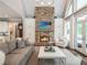 Inviting living room with a stone fireplace, built-in cabinets, and comfortable seating arrangement at 8957 Old Southwick Pass, Johns Creek, GA 30022