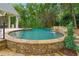 Stunning freeform pool with stone retaining wall and spa, surrounded by lush landscaping at 8957 Old Southwick Pass, Johns Creek, GA 30022
