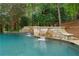 Beautiful pool featuring stone accents and gentle waterfalls for a serene outdoor experience at 8957 Old Southwick Pass, Johns Creek, GA 30022