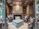 Cozy sitting room with wood-paneled walls, leather chairs, fireplace, and a coffered ceiling at 8957 Old Southwick Pass, Johns Creek, GA 30022