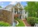 Picturesque backyard featuring a multi-tiered stone waterfall flowing into a pool with lush, green surroundings at 8957 Old Southwick Pass, Johns Creek, GA 30022