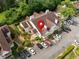 Aerial view of property with ample parking, mature trees, and architectural roof detail at 904 Bridge Se Ln, Smyrna, GA 30082
