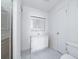 Compact bathroom featuring white tiled floors, a vanity with medicine cabinet and a shower with glass doors at 904 Bridge Se Ln, Smyrna, GA 30082