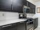 Kitchen area with stainless steel appliances and gray solid surface countertops at 904 Bridge Se Ln, Smyrna, GA 30082