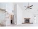 Open living room featuring a fireplace, spiral staircase, and plenty of natural light at 904 Bridge Se Ln, Smyrna, GA 30082