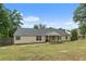 Charming home exterior showcasing a well-maintained backyard with ample green space at 100 Gum Creek Lndg, Oxford, GA 30054