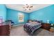 Comfortable bedroom with a ceiling fan, soft carpet, and blue walls at 100 Gum Creek Lndg, Oxford, GA 30054