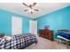 Inviting blue bedroom with a ceiling fan, neutral carpet, and a calming atmosphere at 100 Gum Creek Lndg, Oxford, GA 30054