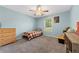 Cozy bedroom with blue walls, ceiling fan, and plaid bedding for a warm, inviting space at 100 Gum Creek Lndg, Oxford, GA 30054
