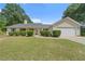 Lovely ranch-style home with a well-maintained front yard, symmetrical landscaping, and an attached garage at 100 Gum Creek Lndg, Oxford, GA 30054