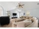Comfortable living room featuring a large sectional sofa, ceiling fan, and convenient access to other areas of the home at 100 Gum Creek Lndg, Oxford, GA 30054