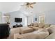 Bright living room with a neutral color palette, ceiling fan, open to the kitchen and comfortable seating at 100 Gum Creek Lndg, Oxford, GA 30054