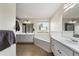 Bright bathroom featuring a bathtub, white vanities with dual sinks, and mirrors at 100 Gum Creek Lndg, Oxford, GA 30054