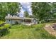 Spacious backyard with mature trees and a patio featuring a hot tub at 1095 Dallas Nebo Rd, Dallas, GA 30157