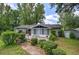 Single-story home featuring a screened-in porch and wooden deck surrounded by green landscaping at 1095 Dallas Nebo Rd, Dallas, GA 30157