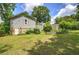 Spacious backyard featuring lush greenery, a stone foundation, and garden at 1095 Dallas Nebo Rd, Dallas, GA 30157