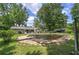 Backyard view of a swimming pool needing cleaning, surrounded by lush trees at 1095 Dallas Nebo Rd, Dallas, GA 30157