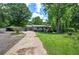 Single-story home featuring a long driveway, storage shed and well-manicured front yard at 1095 Dallas Nebo Rd, Dallas, GA 30157