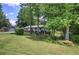 Charming single-story home featuring a cozy front porch and lush green lawn surrounded by mature trees at 1095 Dallas Nebo Rd, Dallas, GA 30157