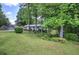 Charming single-story home featuring a cozy front porch and lush green lawn surrounded by mature trees at 1095 Dallas Nebo Rd, Dallas, GA 30157