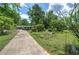 Inviting single-story home with a long driveway and well-manicured lawn and landscaping at 1095 Dallas Nebo Rd, Dallas, GA 30157