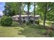 Charming single-story home featuring a cozy front porch and lush green lawn surrounded by mature trees at 1095 Dallas Nebo Rd, Dallas, GA 30157
