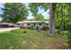 Charming single-story home featuring a cozy front porch and a well-maintained lawn with mature trees at 1095 Dallas Nebo Rd, Dallas, GA 30157