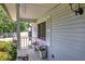 Charming front porch with decorative flower pots and a quaint bench at 1095 Dallas Nebo Rd, Dallas, GA 30157