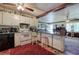 The kitchen has an eat-in counter, white cabinets, appliances, and view to another room at 1095 Dallas Nebo Rd, Dallas, GA 30157