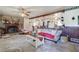 Cozy living room with a stone fireplace, ceiling fan, and an open floor plan at 1095 Dallas Nebo Rd, Dallas, GA 30157