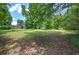 Open yard with scattered mature trees creating a tranquil and natural setting at 1095 Dallas Nebo Rd, Dallas, GA 30157