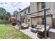 Lawn features a covered patio with outdoor seating, play set, and a grill at 3514 Ethridge Nw Ln, Kennesaw, GA 30144