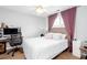 Cozy bedroom featuring soft carpet, purple curtains, and a comfortable bed with lots of pillows at 3514 Ethridge Nw Ln, Kennesaw, GA 30144