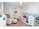 Bedroom featuring crib, rocker, and bookshelves at 3514 Ethridge Nw Ln, Kennesaw, GA 30144