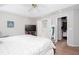 Spacious bedroom featuring ceiling fan, tv, and doorway to large walk-in closet at 3514 Ethridge Nw Ln, Kennesaw, GA 30144