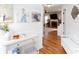 Inviting entryway with hardwood floors, console table, and a glimpse into the living room with a fireplace at 3514 Ethridge Nw Ln, Kennesaw, GA 30144