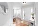 Stylish entryway with wood floors, white wainscoting, console table, and a view into the dining room at 3514 Ethridge Nw Ln, Kennesaw, GA 30144
