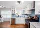 Bright kitchen with white cabinets, granite countertops, stainless steel appliances, and blue backsplash at 3514 Ethridge Nw Ln, Kennesaw, GA 30144