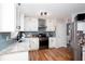 Well-lit kitchen with stainless steel appliances, granite counters and blue subway tile backsplash at 3514 Ethridge Nw Ln, Kennesaw, GA 30144