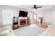 Cozy living room featuring hardwood floors, a fireplace, and large windows at 3514 Ethridge Nw Ln, Kennesaw, GA 30144