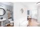 Cozy powder room with a pedestal sink, round mirror, and modern decor at 3514 Ethridge Nw Ln, Kennesaw, GA 30144