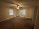 Well-lit carpeted bedroom with a ceiling fan and closet at 4718 City View Dr, Forest Park, GA 30297