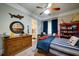 bedroom with nautical decor, wood dresser, and striped bedding; bathroom is visible at 118 Whitestone Dr, Mcdonough, GA 30253