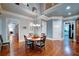 Bright dining room features hardwood floors, a round table, and traditional decor at 118 Whitestone Dr, Mcdonough, GA 30253