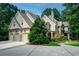 View of the exterior featuring a three-car garage and manicured landscaping at 118 Whitestone Dr, Mcdonough, GA 30253