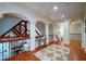 Upstairs hallway with hardwood floors, decorative rug, arched doorways, and exposed beams at 118 Whitestone Dr, Mcdonough, GA 30253